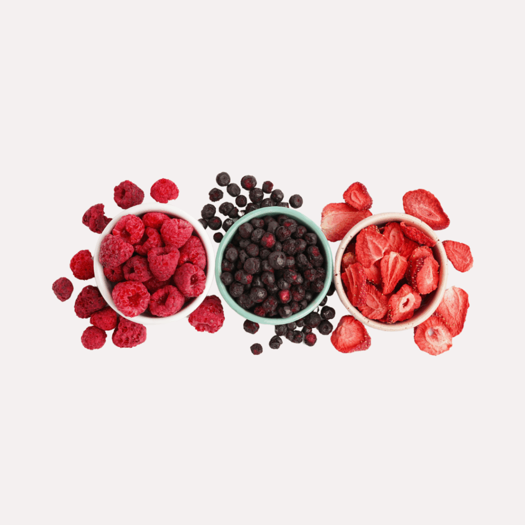 three bowls with red and black fruits on white background